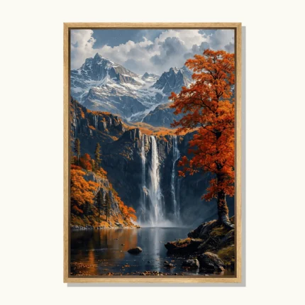 Tall waterfall flowing into a lake beneath snow-capped mountains, surrounded by orange autumn trees and rocky cliffs.